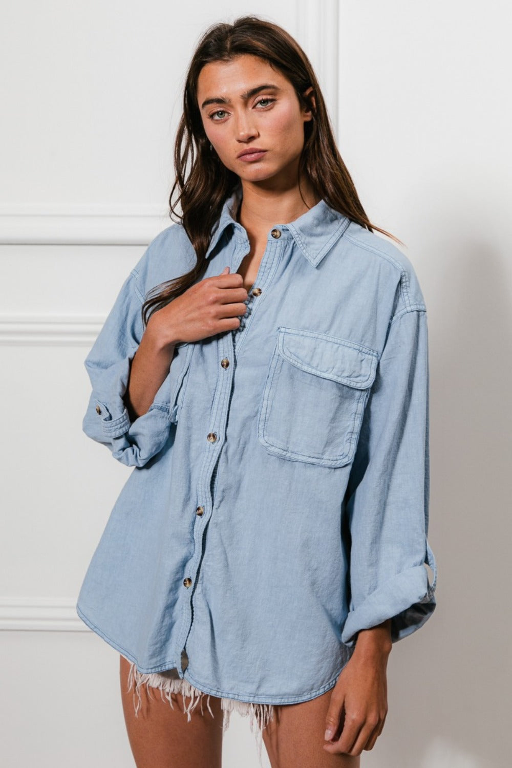 Denim button down shirt with stitch detail and chest pockets, model wearing stylish casual fashion.