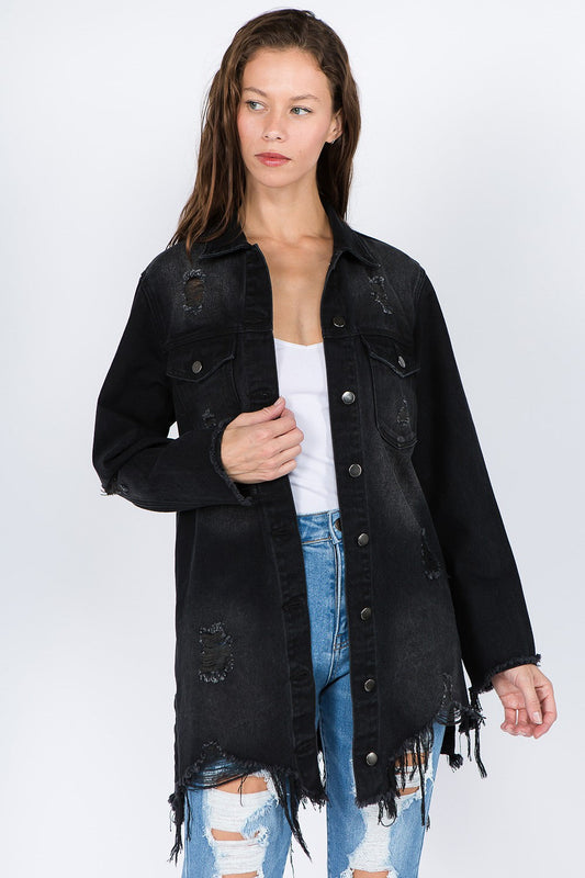 Woman wearing distressed frayed hem denim jacket with edgy raw details and button-front closure, styled with ripped jeans.