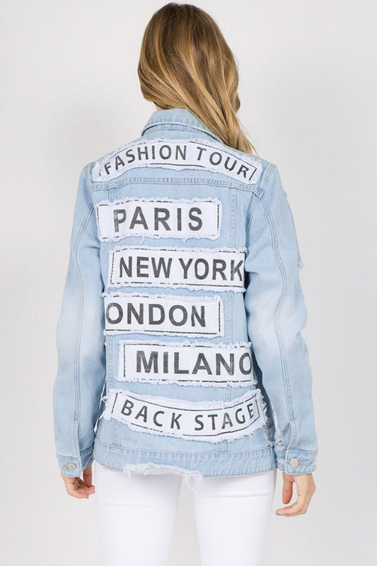 Trendy letter patched distressed denim jacket with global city names on the back, perfect for casual or stylish looks.