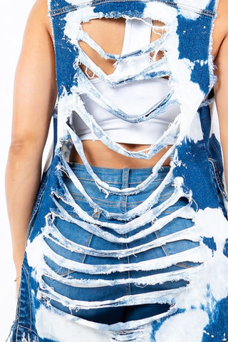 Distressed frayed edge denim vest with raw hem and back cutout design, showcasing trendy and stylish details.
