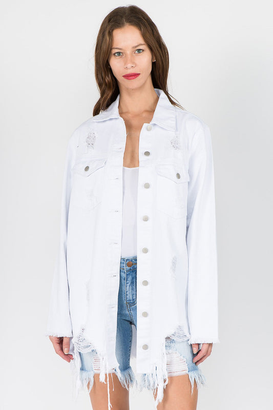 Woman wearing distressed frayed hem denim jacket with raw edges and relaxed fit, perfect for trendy, versatile styling.