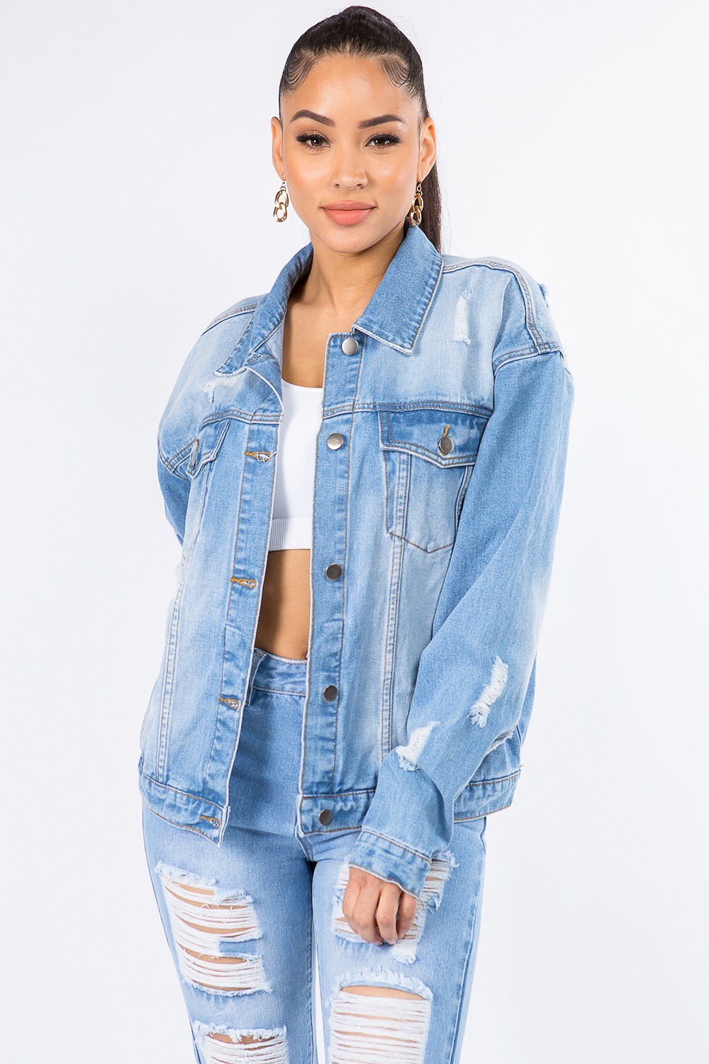 Graphic distressed long sleeve denim jacket in light blue with vintage-inspired design and bold worn look.