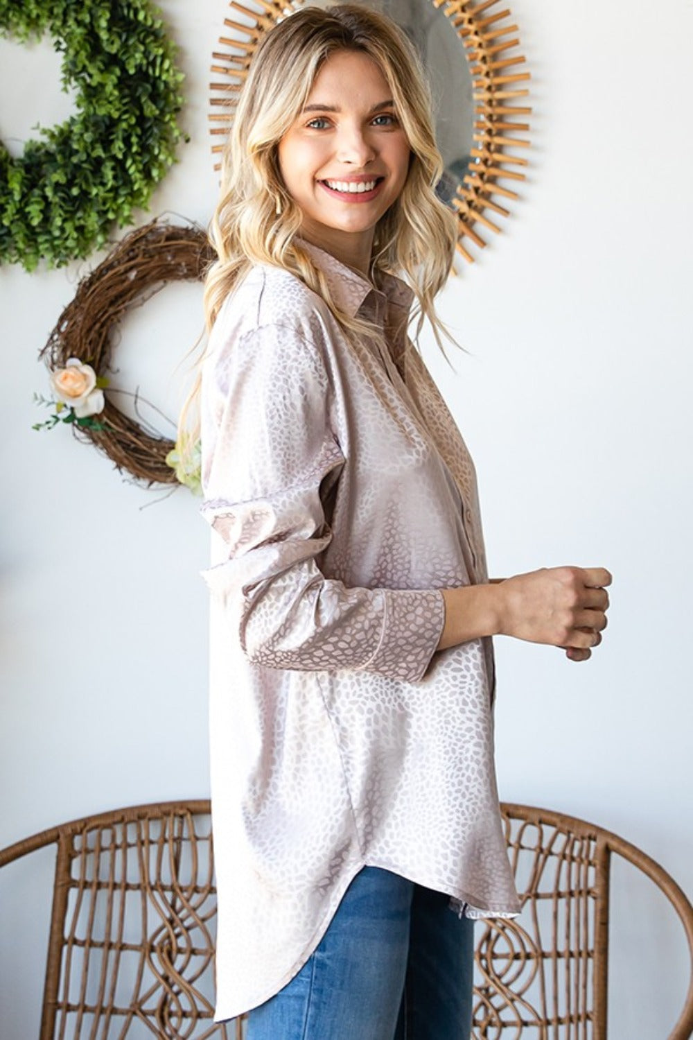 Woman wearing a Ditsy Dot Button Down Collared Satin Shirt with a stylish safari print, showcasing its slight stretch and comfortable fit.