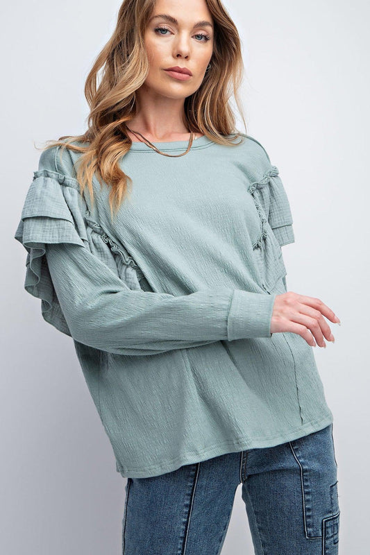 Faded blue double ruffle sleeves top with rounded neckline and relaxed fit, featuring dropped shoulders and center back seam detailing.