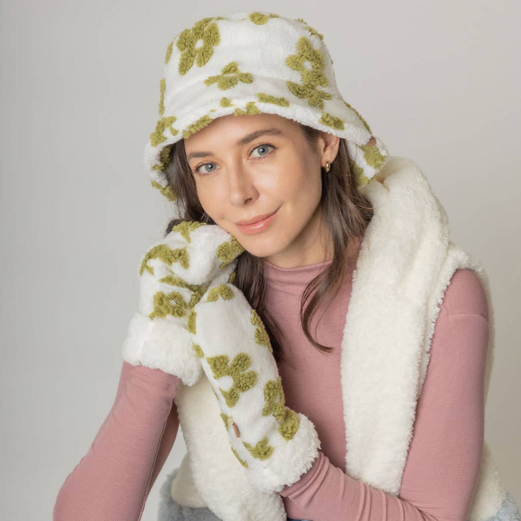 Woman wearing a winter flower pattern Sherpa bucket hat with matching gloves and cozy outfit.