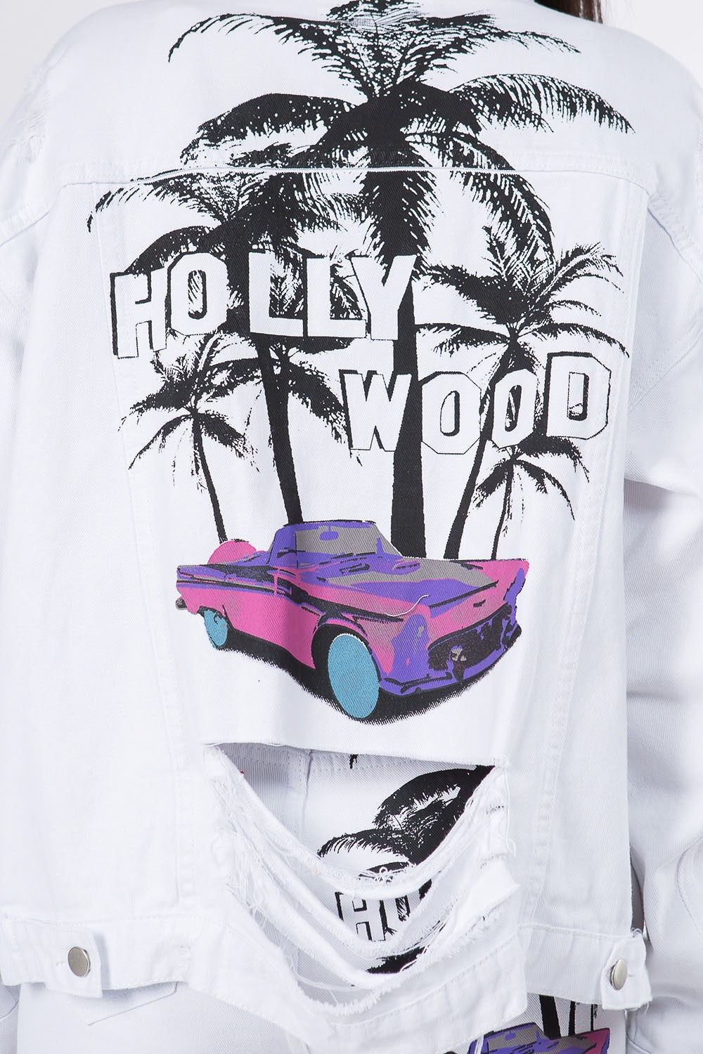 White denim jacket with palm tree and car graphic print, featuring the word "Hollywood" in bold letters on the back.