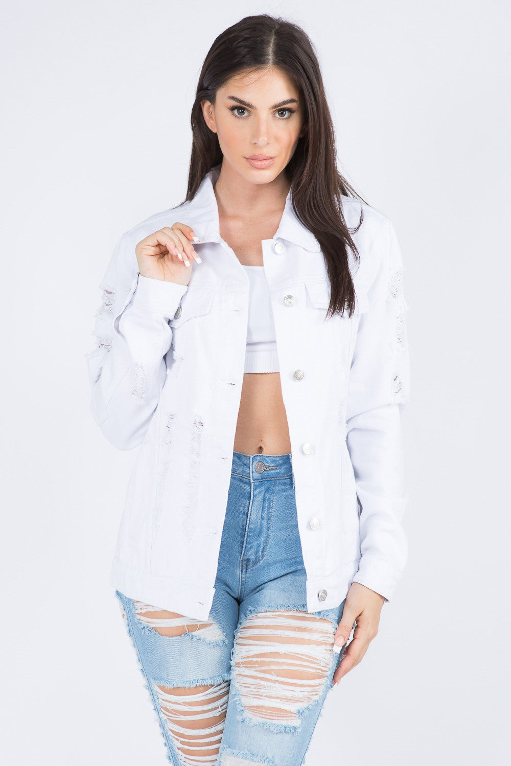 Trendy distressed denim jacket with button-down styling, medium wash, buttoned cuffs, and hip pockets for an edgy, fashionable look.