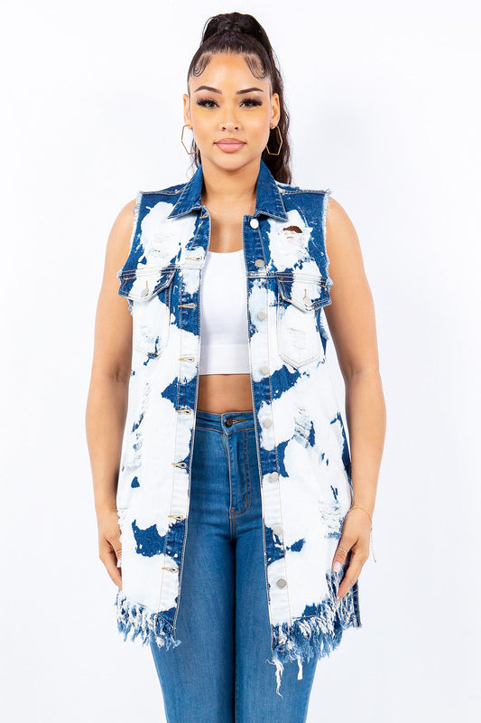 Woman wearing distressed frayed edge longline denim vest with a trendy raw hem and button front closure.