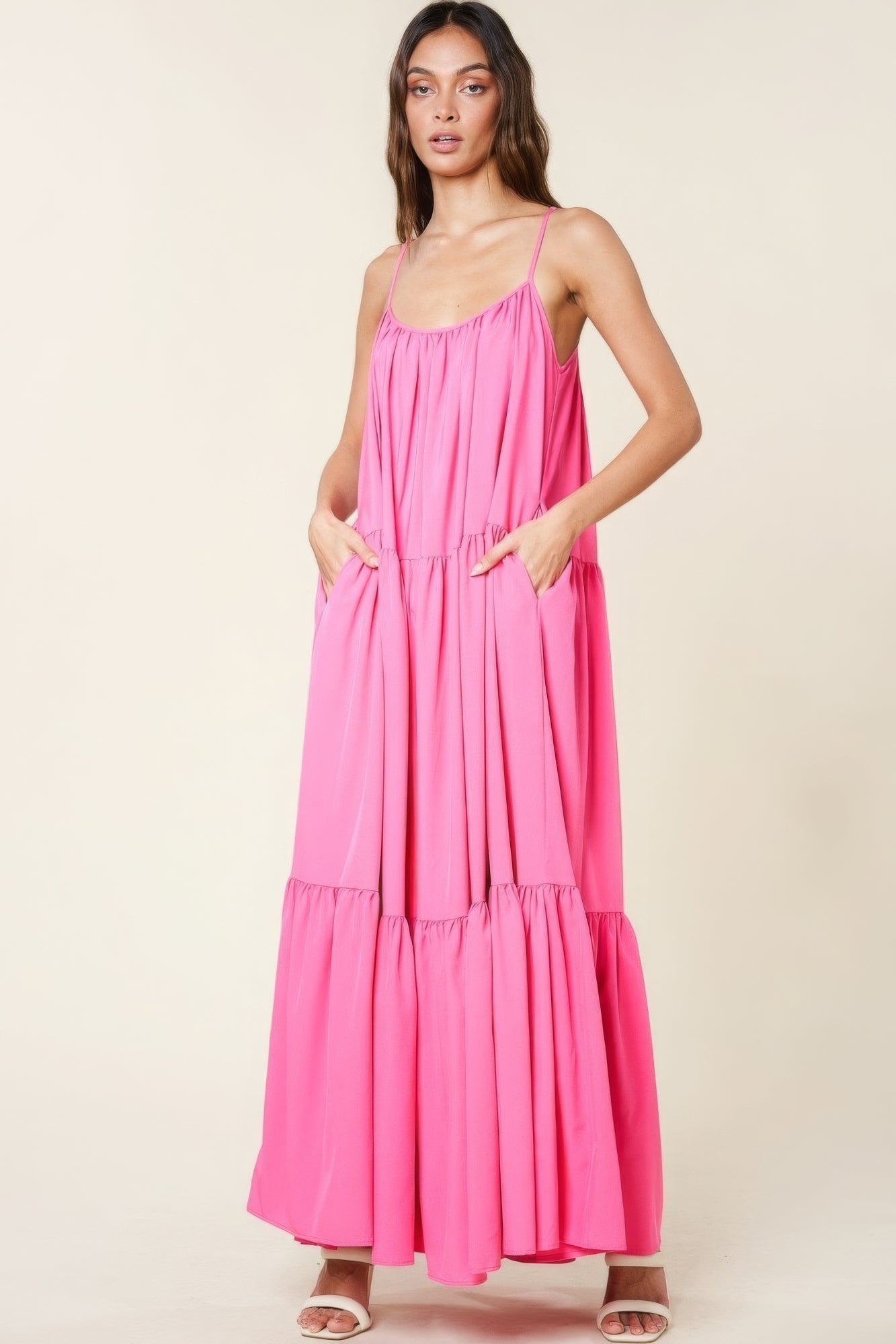 Woman wearing pink maxi sun dress with pockets and adjustable straps