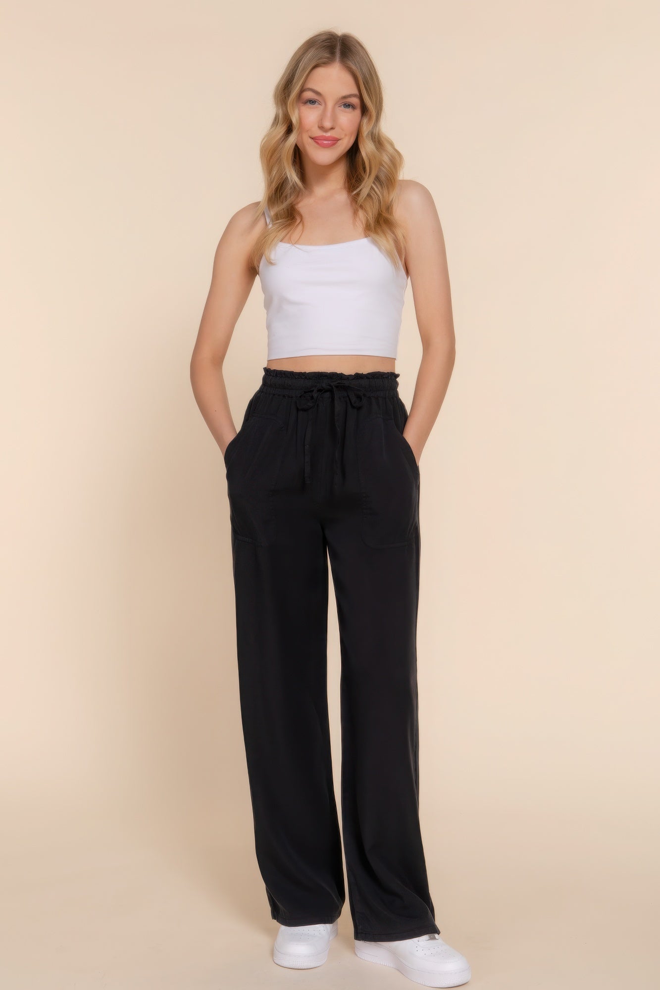 Woman wearing black elastic waist Tencel long pants with a white top, showcasing casual elegance and comfort.