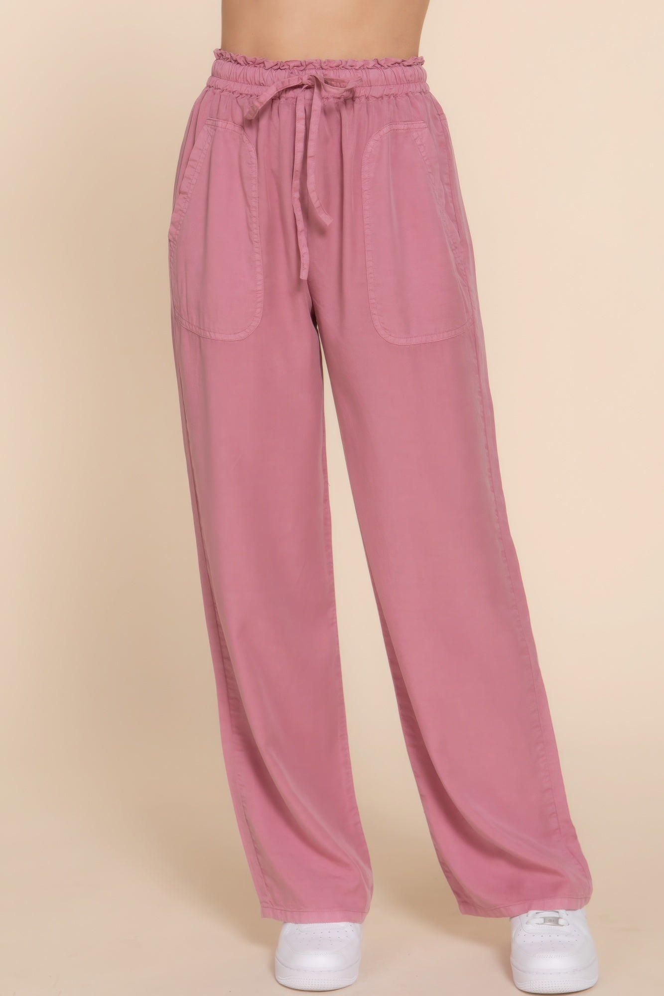 Pink elastic waist Tencel long pants with pockets and drawstring, showcasing relaxed fit and comfortable style for versatile wear.