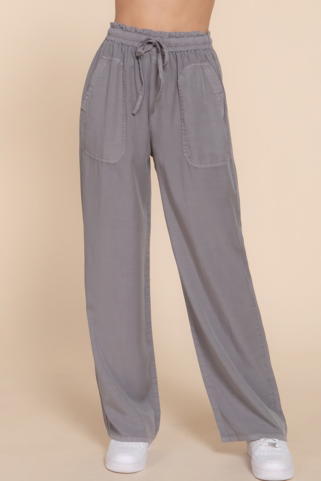 Gray elastic waist Tencel long pants with side pockets, offering a comfortable and stylish fit for everyday wear.