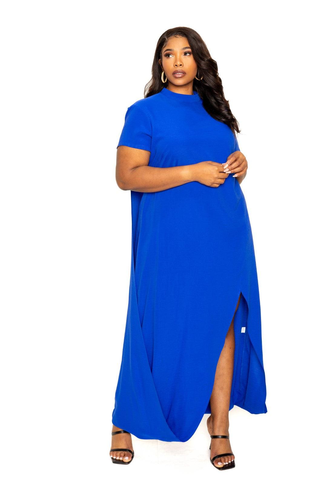 Plus-size model wearing a royal blue mock neck back cape dress with slit, perfect for elegant occasions.