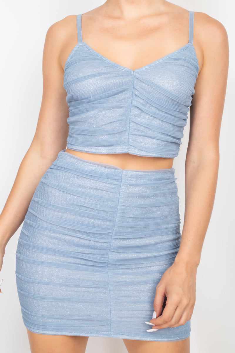 Dusty blue shirred cami top and mini skirt set with honeycomb design and adjustable straps, featuring a bodycon fit.