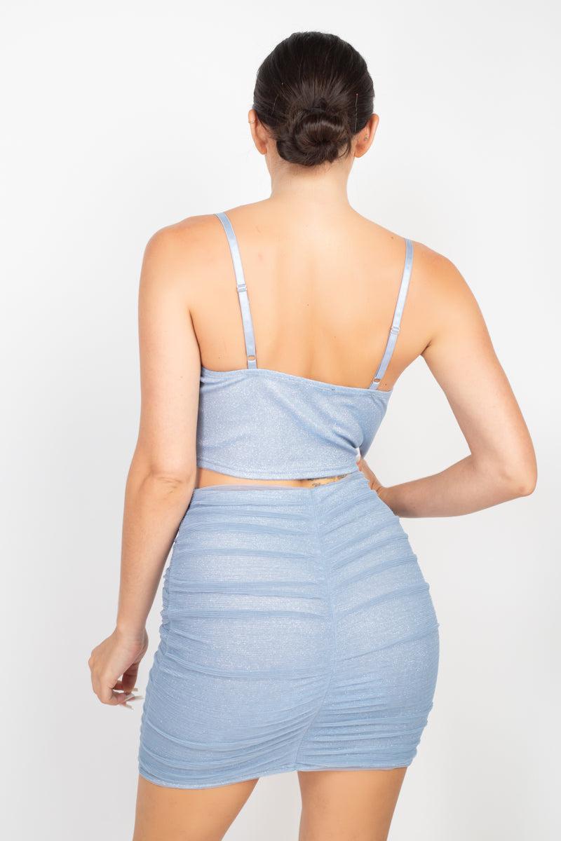 Dusty blue shirred cami top and mini skirt set with adjustable straps and back zipper, featuring a bodycon silhouette.