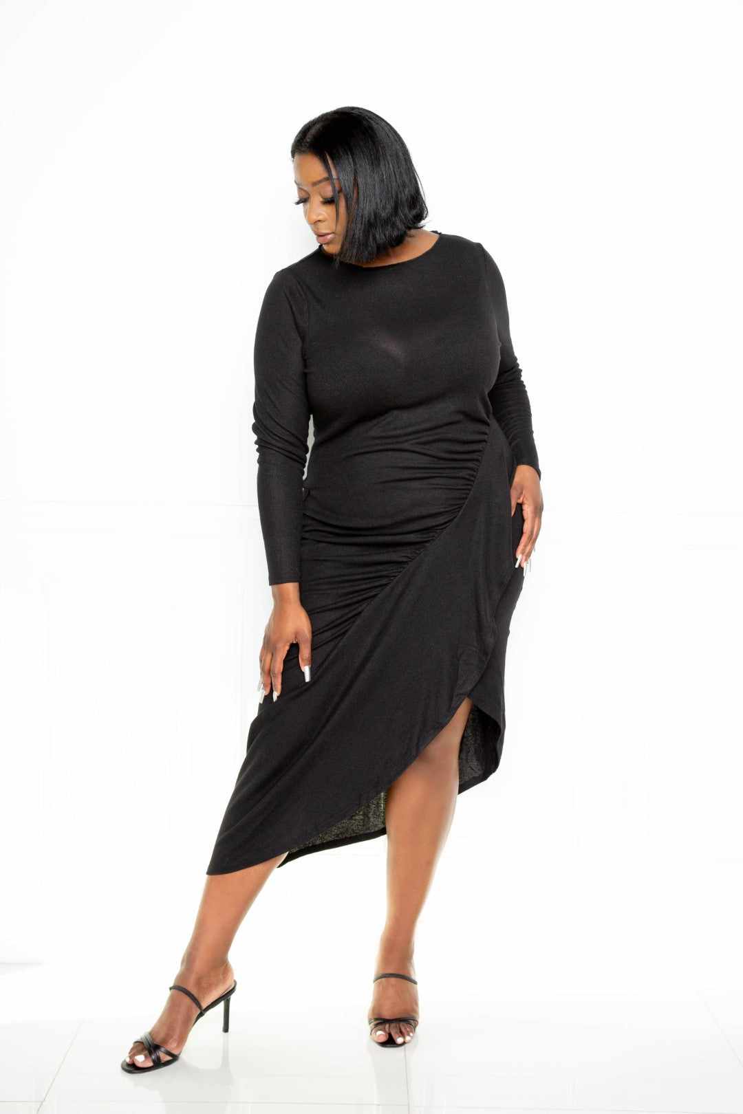 Black sweater dress featuring cascading waterfall ruffle and asymmetrical design, made from polyester and spandex for comfortable fit.