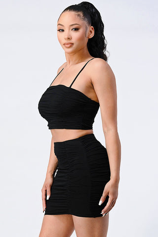 Woman wearing Evelyn Mesh Cropped Cami and Skirt Set in black, featuring a stretchy, soft, and chic design.