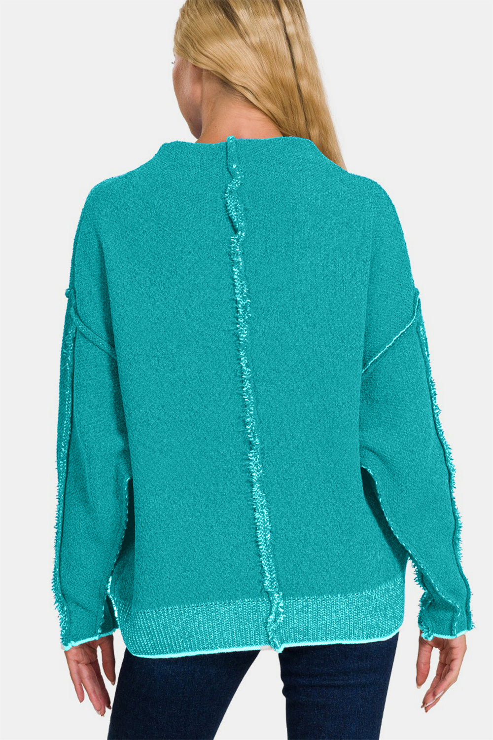 Exposed seam mock neck long sleeve teal sweater with trendy design, crafted from soft polyester-acrylic blend for versatile styling.