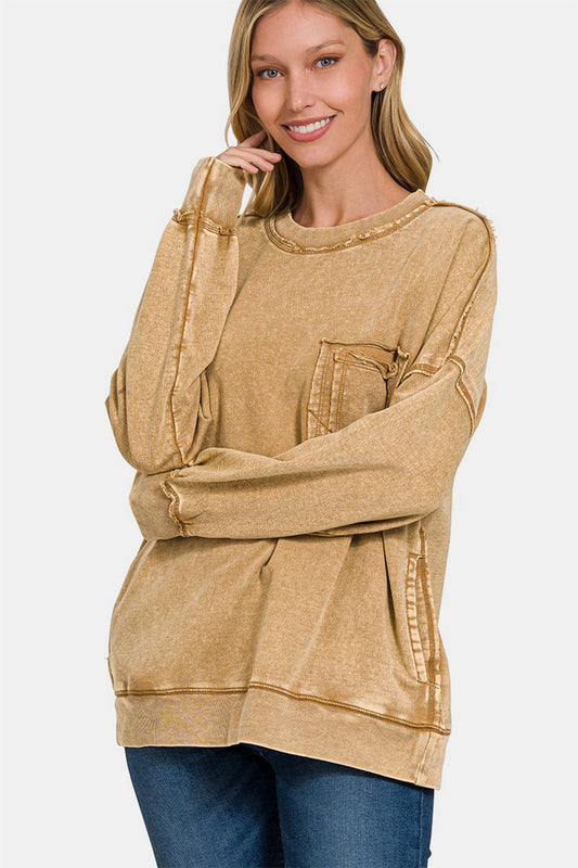 Woman wearing exposed seam round neck dropped shoulder cotton sweatshirt with trendy deconstructed style.