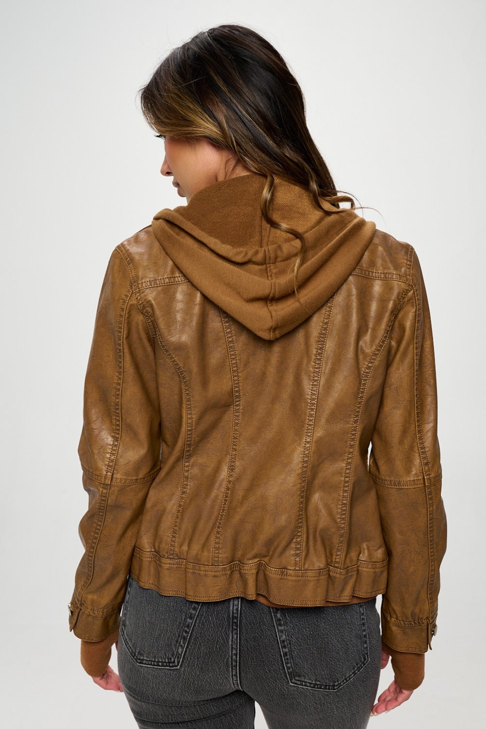 Woman wearing a brown Coalition LA Double Zip Hooded Long Sleeve Jacket, showing back design with double zippers and a hood.