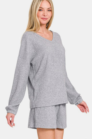 Gray V-neck long sleeve ribbed top and shorts set made of polyester, rayon, and spandex, featuring a basic style with slight stretch.