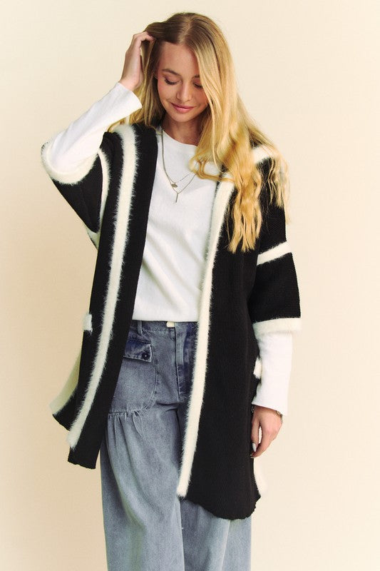 Woman wearing Davi & Dani Fuzzy Trim Open Front Loose Fit Cardigan with black and white stripes, pocketed, perfect for layering.