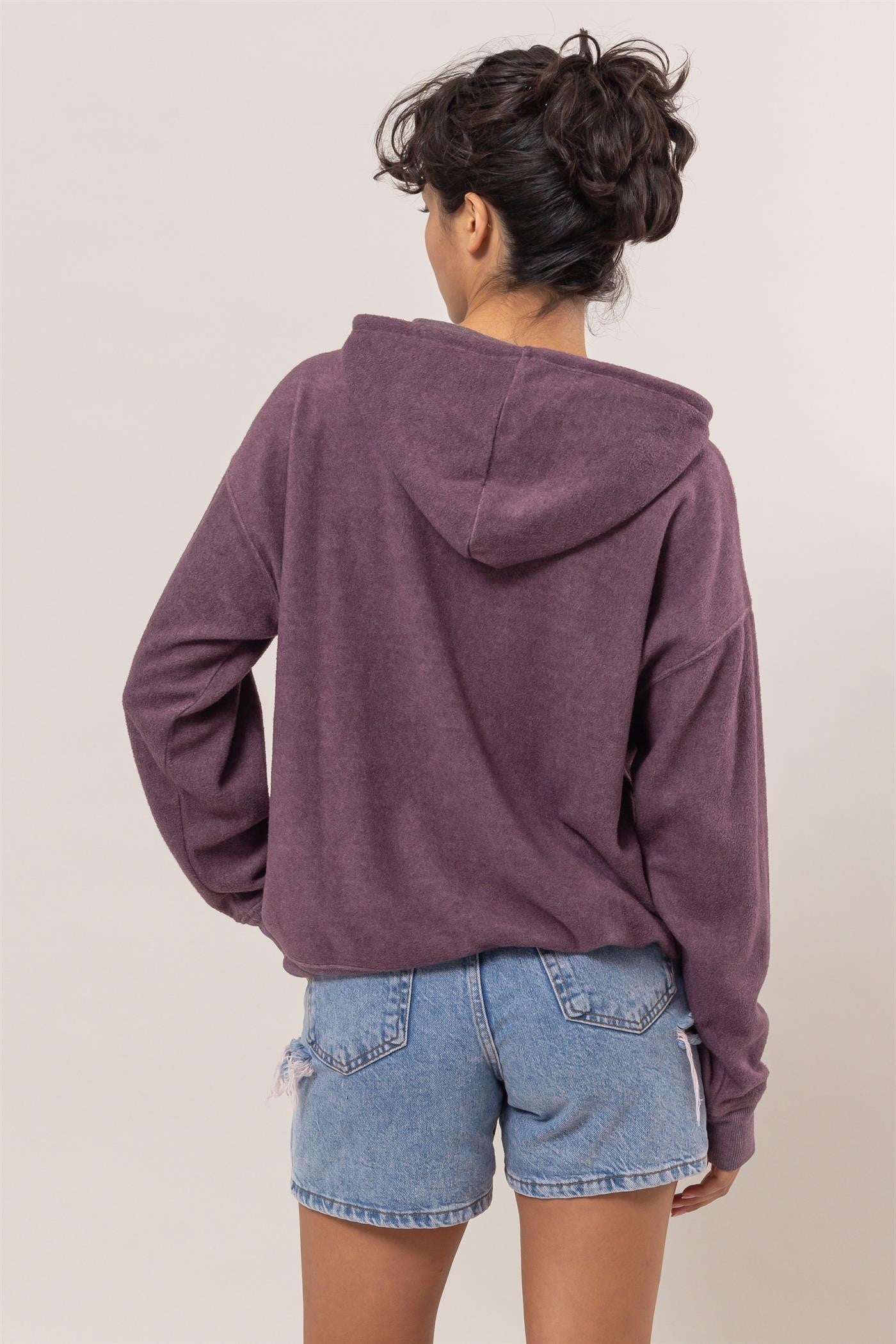 Dark plum brushed long sleeve hoodie with kangaroo pocket, worn by model, showcasing back view and casual style.