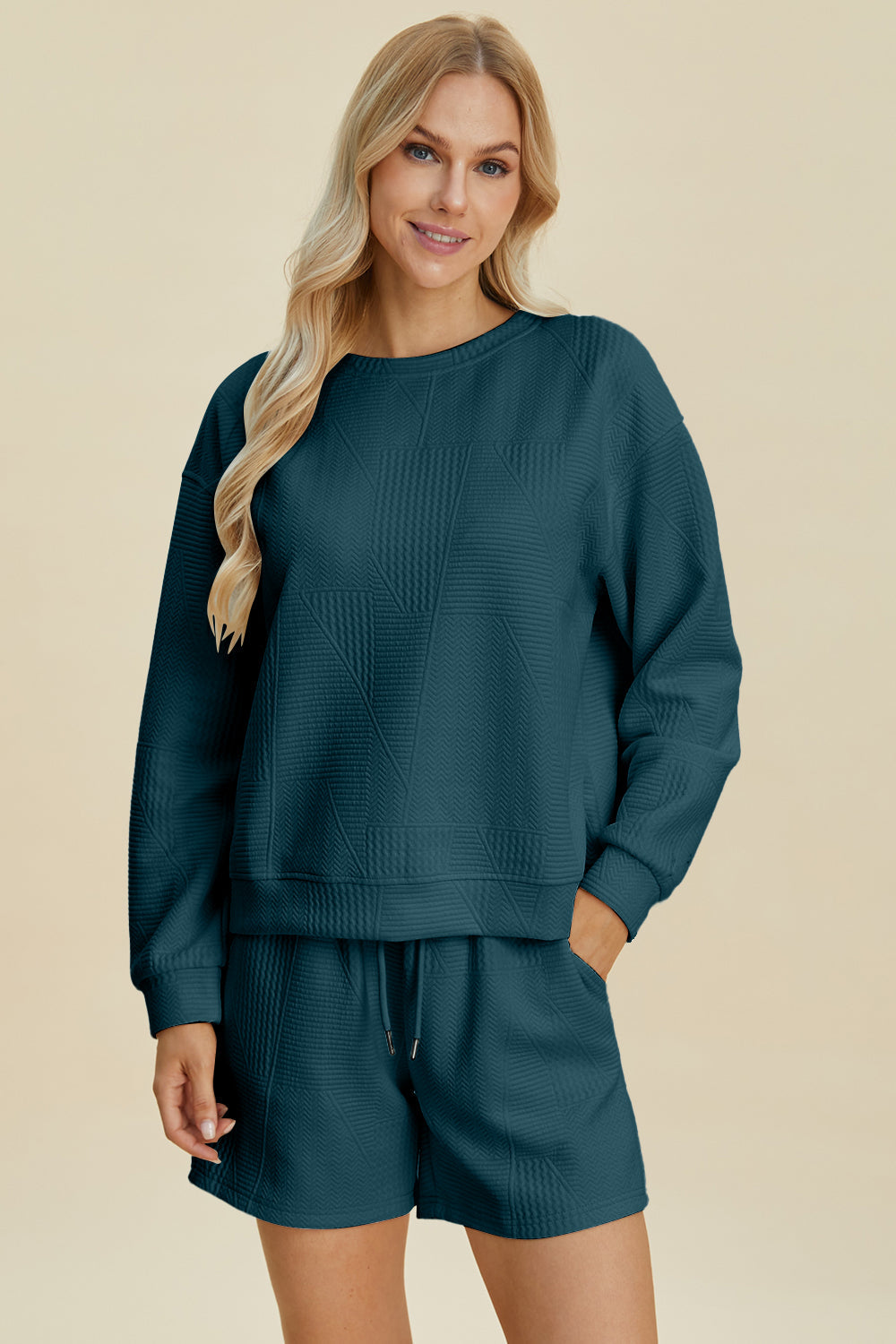 Woman wearing green textured long sleeve top and shorts set with drawstring, fall fashion apparel, 98% polyester, 2% elastane.