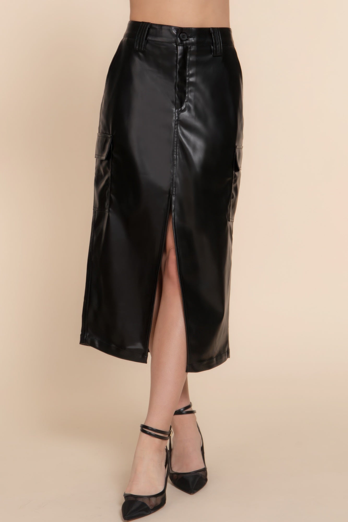 Sleek black faux leather midi cargo skirt with front slit and pockets, perfect for any occasion.