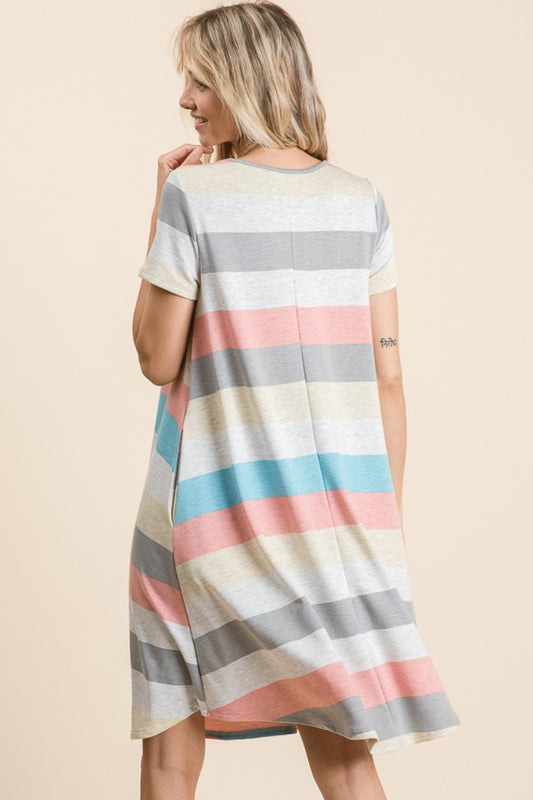 Woman wearing multicolor striped short sleeve dress with pockets, featuring basic style, slightly stretchy fabric, side view.