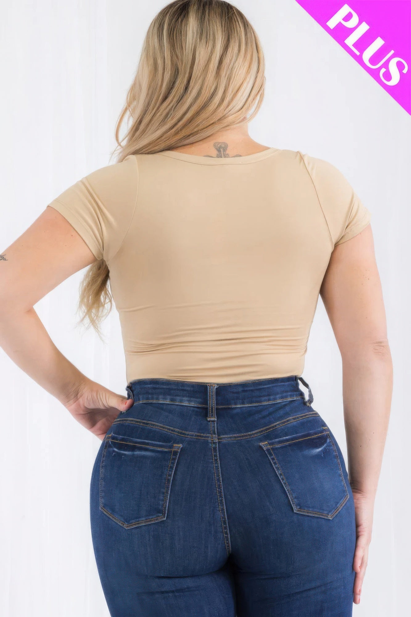 Plus size short sleeve bodysuit in solid color with a split neck, paired with jeans for a stylish and casual look.