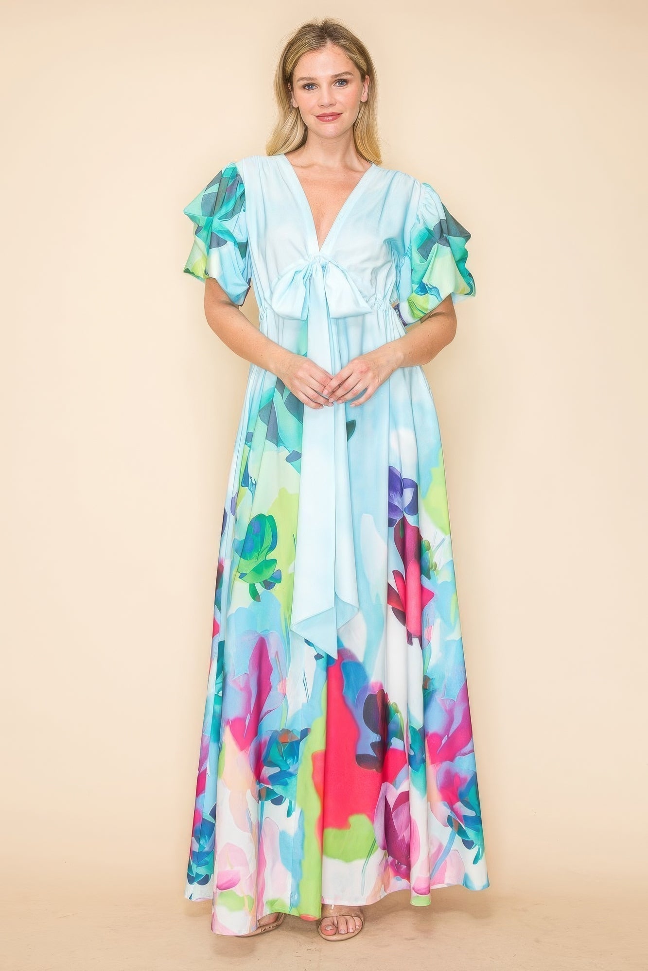 Multi-color printed V neck maxi dress with self-tie ribbon, elastic waistband, pockets, and flowy skirt, perfect for versatile styling.