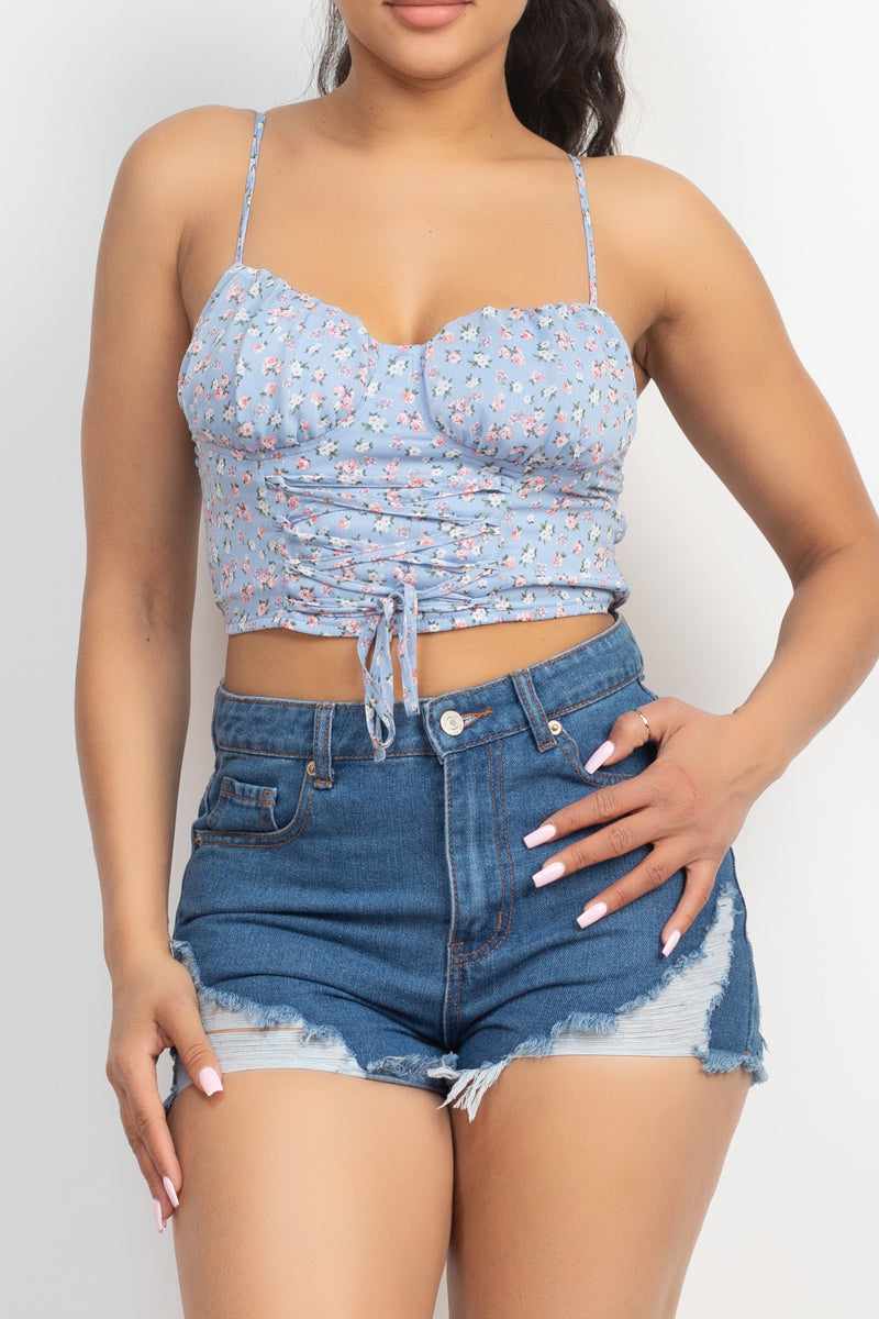 Blue floral front tie top with sweetheart neckline and adjustable straps, paired with denim shorts for a stylish look.