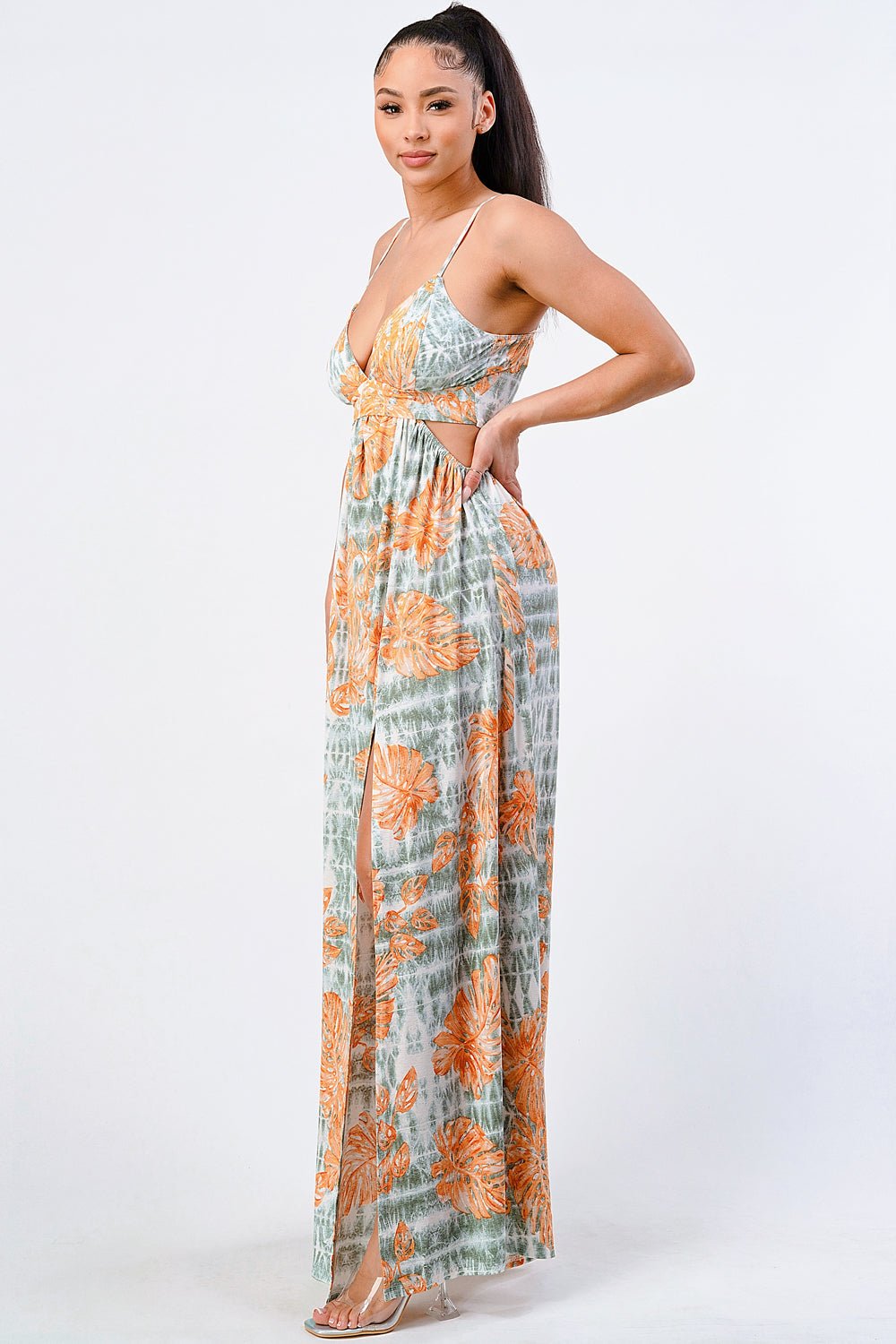Woman wearing floral printed side slit maxi dress in orange and gray with spaghetti straps, ideal for spring and summer fashion.