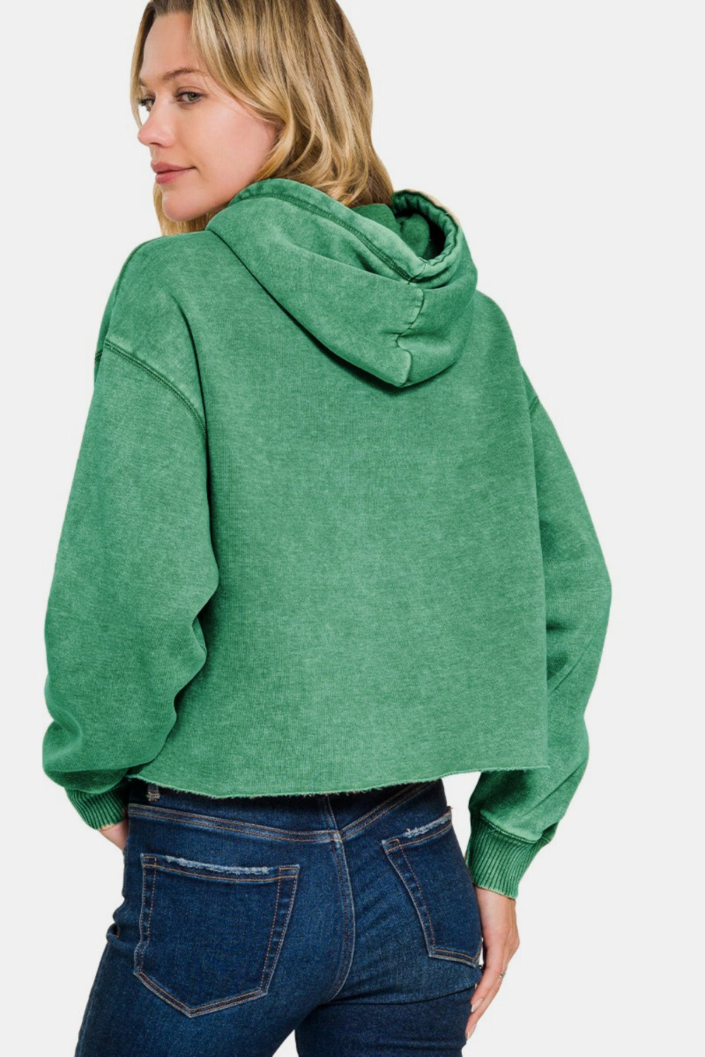 Woman wearing green acid wash cropped fleece hoodie, showcasing trendy and vintage-inspired fashion style.