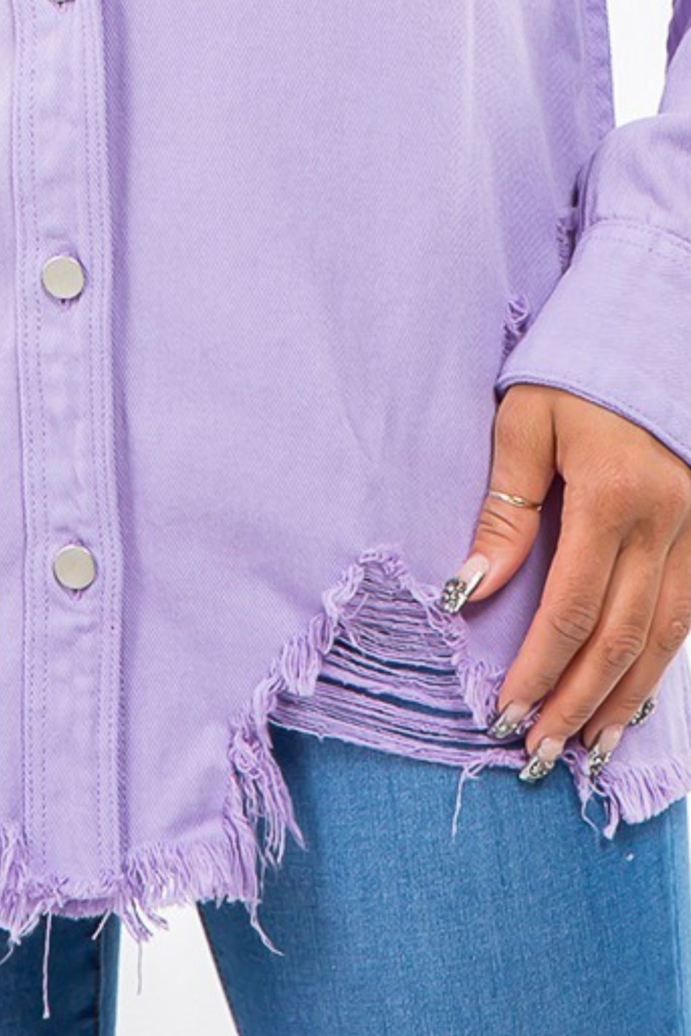 Lavender distressed denim jacket with frayed hem and silver buttons, showcasing trendy lived-in style and casual comfort.