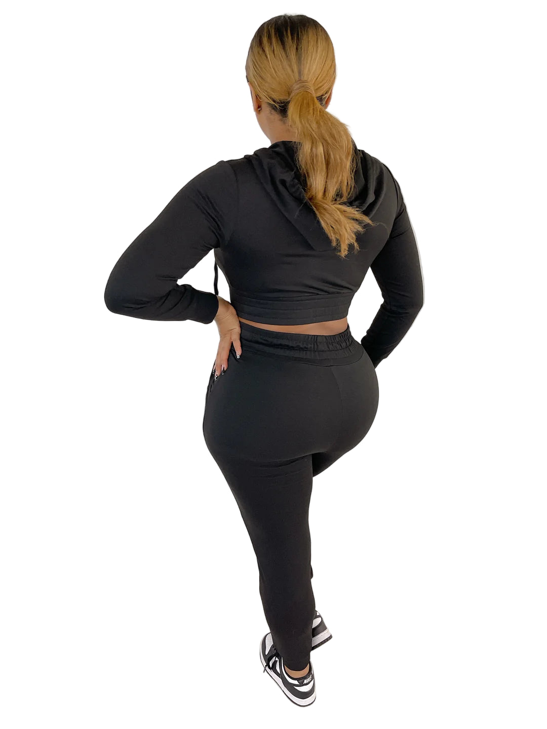 Woman wearing a black French Terry Jacket & Pants Set, showcasing a stylish and comfortable fit against a white panel background.