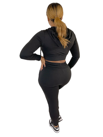 Woman wearing a black French Terry Jacket & Pants Set, showcasing a stylish and comfortable fit against a white panel background.