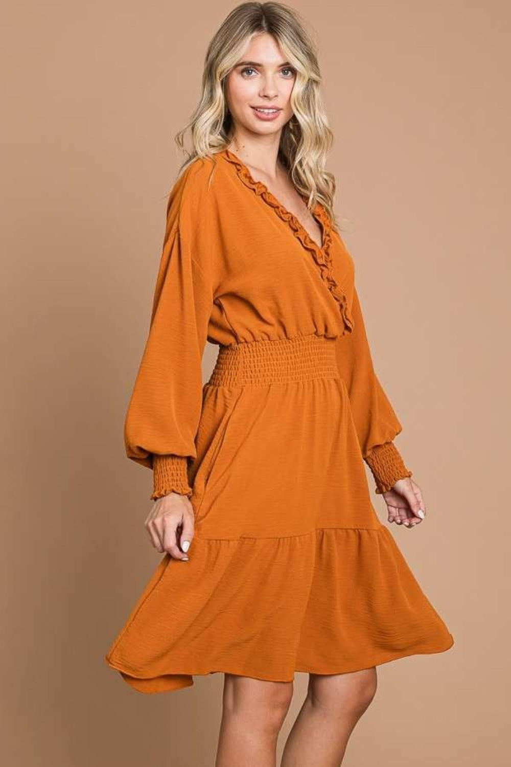 Stylish frill smocked lantern sleeve mini dress in orange, featuring stretchy polyester fabric and elegant details.