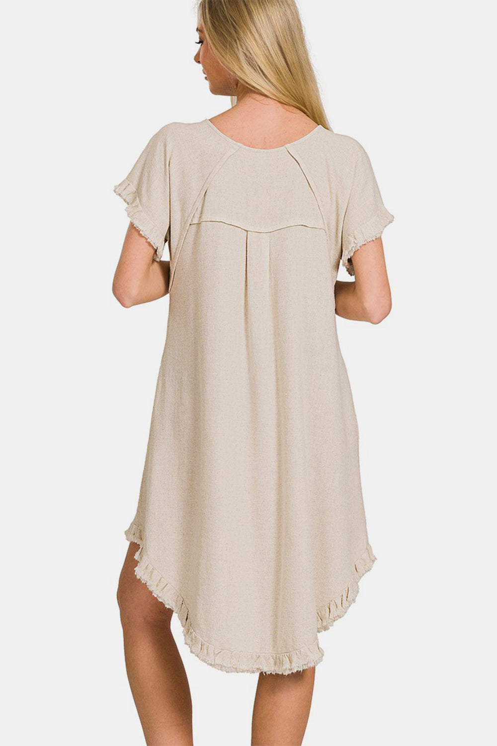 Beige fringe edge high-low flowy dress with pockets, back view, featuring short sleeves and lightweight rayon-linen fabric.