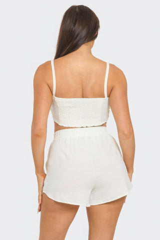 White shorts set with elastic waistband and shirred back, featuring a chic, comfortable design. Perfect for versatile styling.