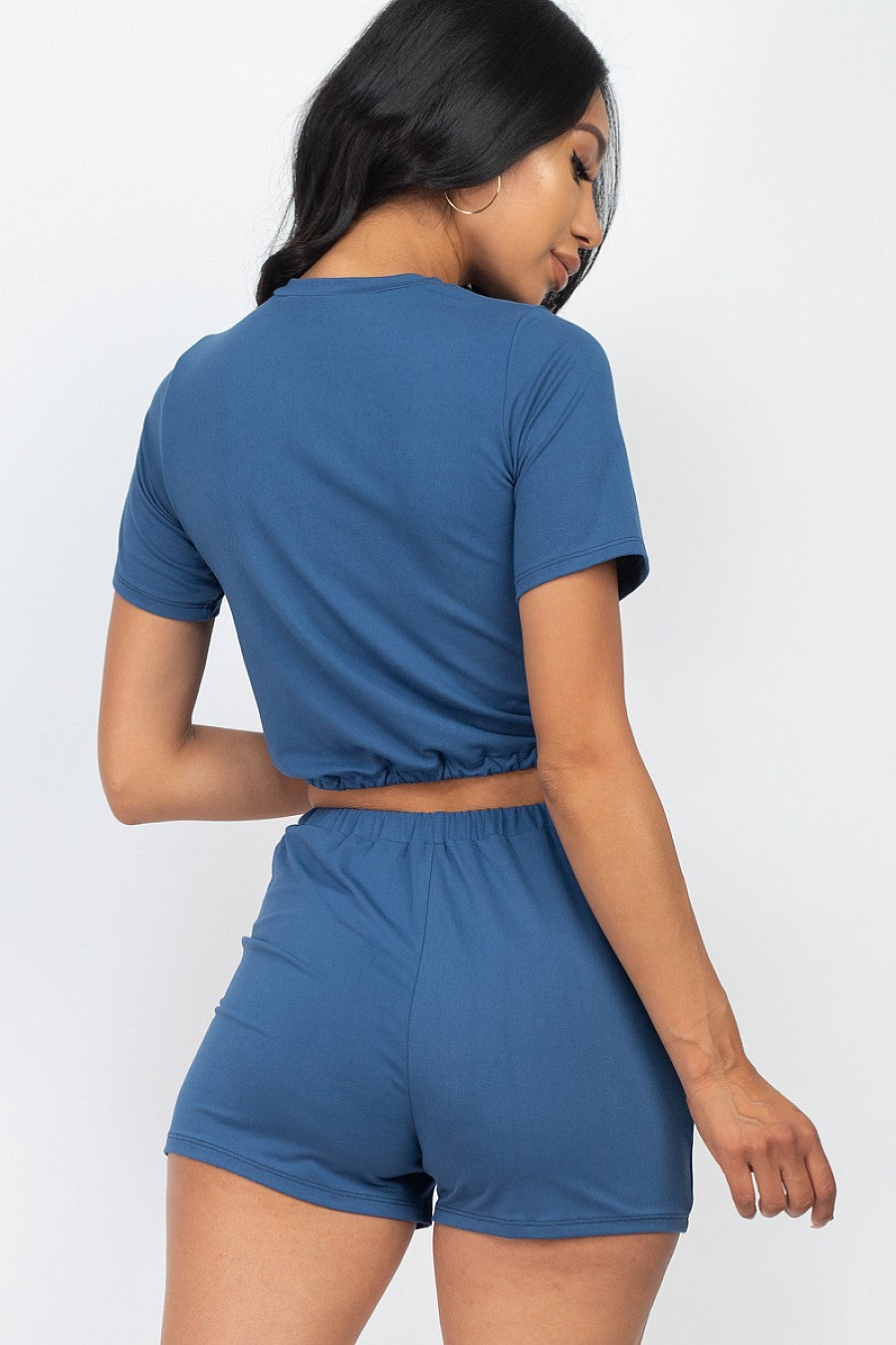 Woman wearing blue front tied crop top & shorts set made of soft Jersey fabric perfect for summer casual wear.