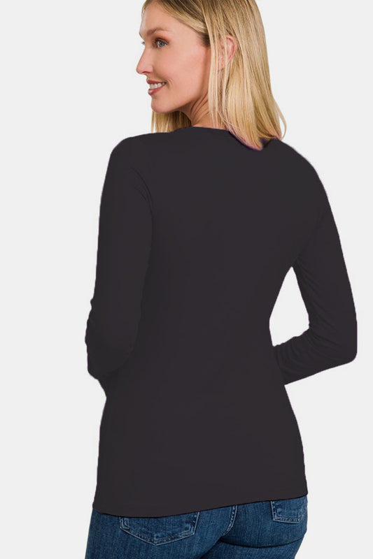 Woman wearing a full size brushed microfiber long sleeve t-shirt with a round neck and slightly stretchy fit in black.