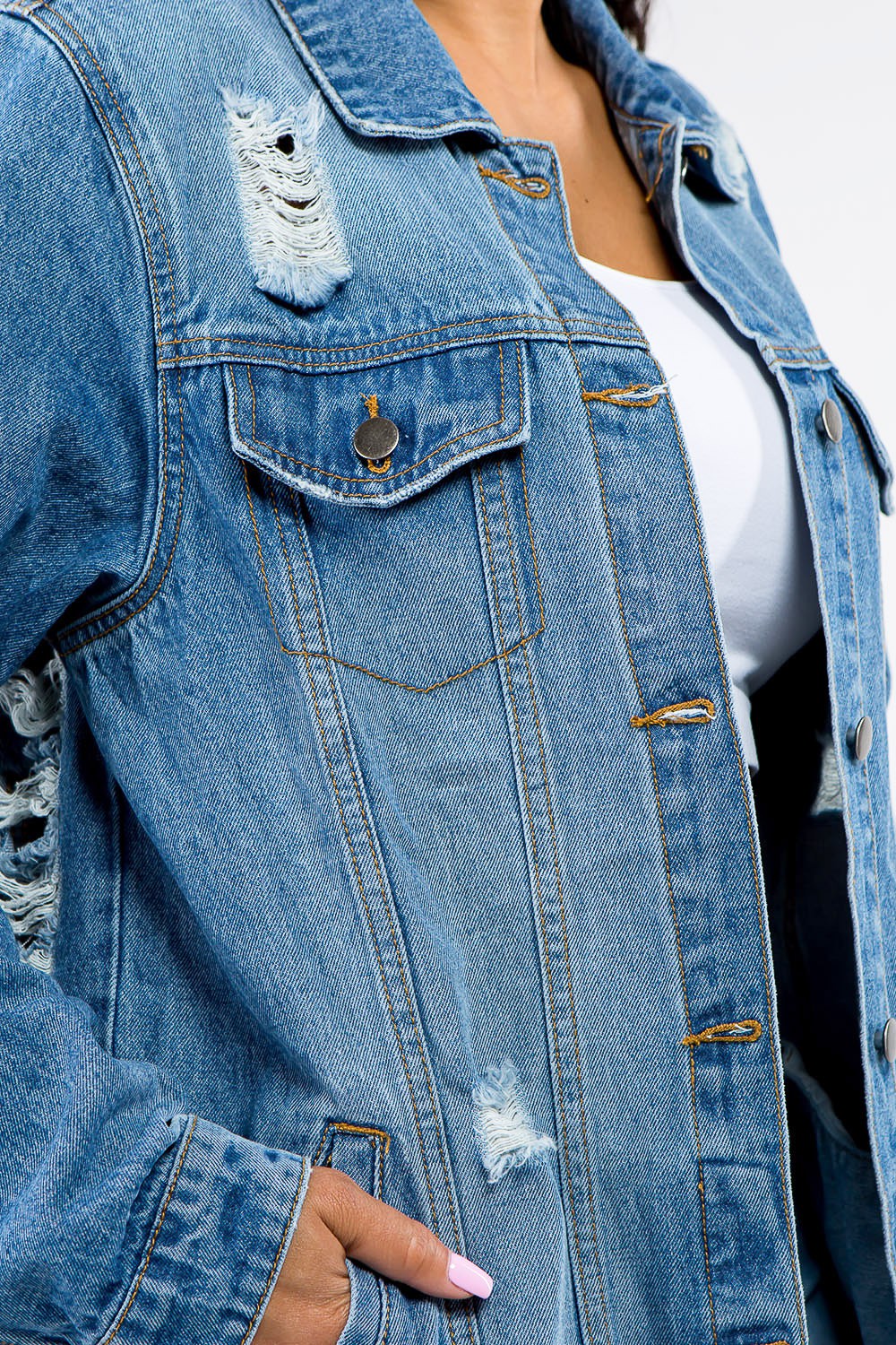 Full size distressed denim jacket with button-up closure, showcasing edgy detailing and durable cotton-polyester blend.