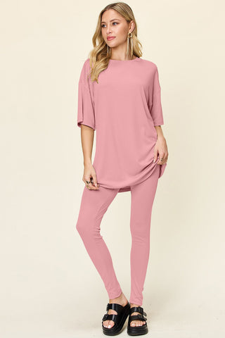 Woman wearing pink double take full size dropped shoulder T-shirt and leggings set, round neck, slightly stretchy fabric.