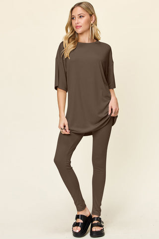 Woman wearing full-size brown dropped shoulder T-shirt and leggings set made of polyester and spandex.
