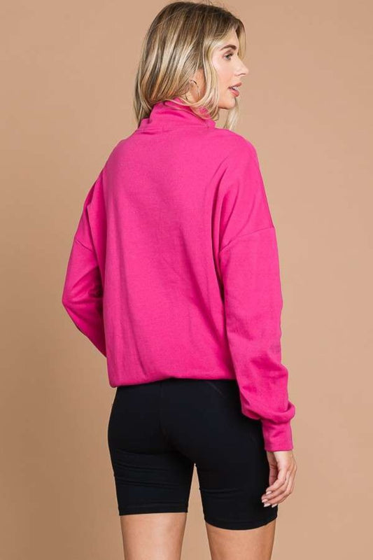 Woman wearing pink full size half zip long sleeve sweatshirt with black shorts, showcasing casual back view style.