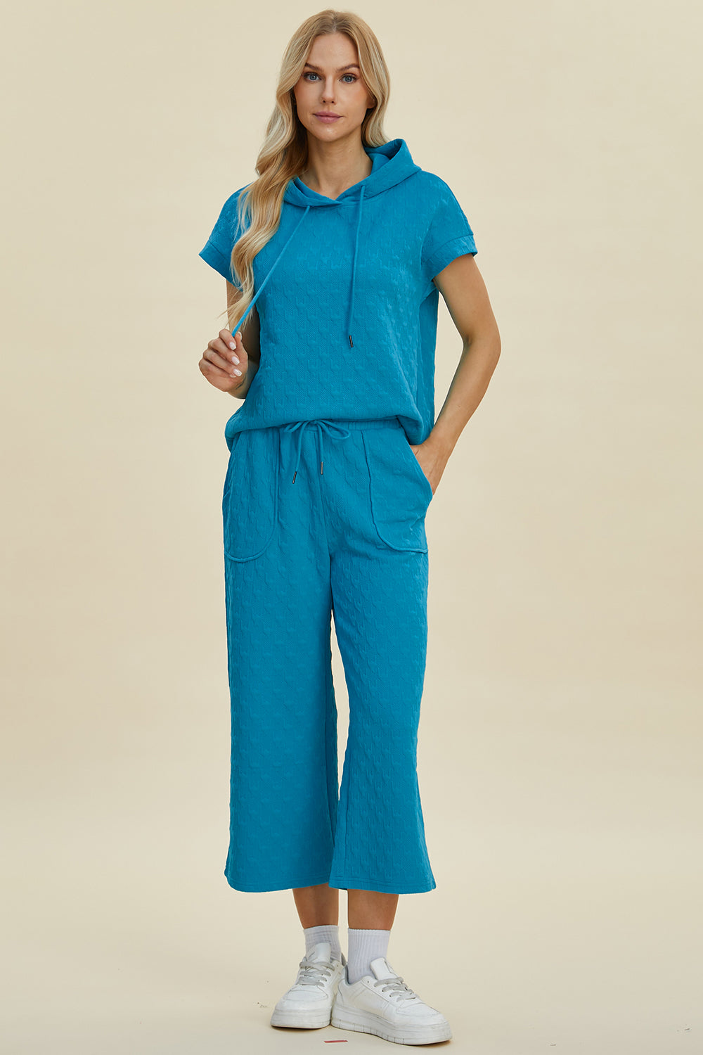 Blue full-size short sleeve hoodie and pocketed pants set with drawstring, made of stretchy polyester and spandex blend.