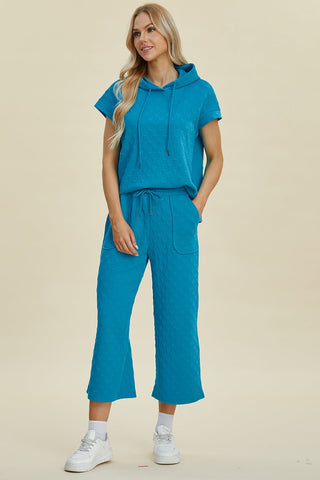 Full size blue short sleeve hoodie and pocketed pants set with drawstring, slightly stretchy polyester-spandex blend.