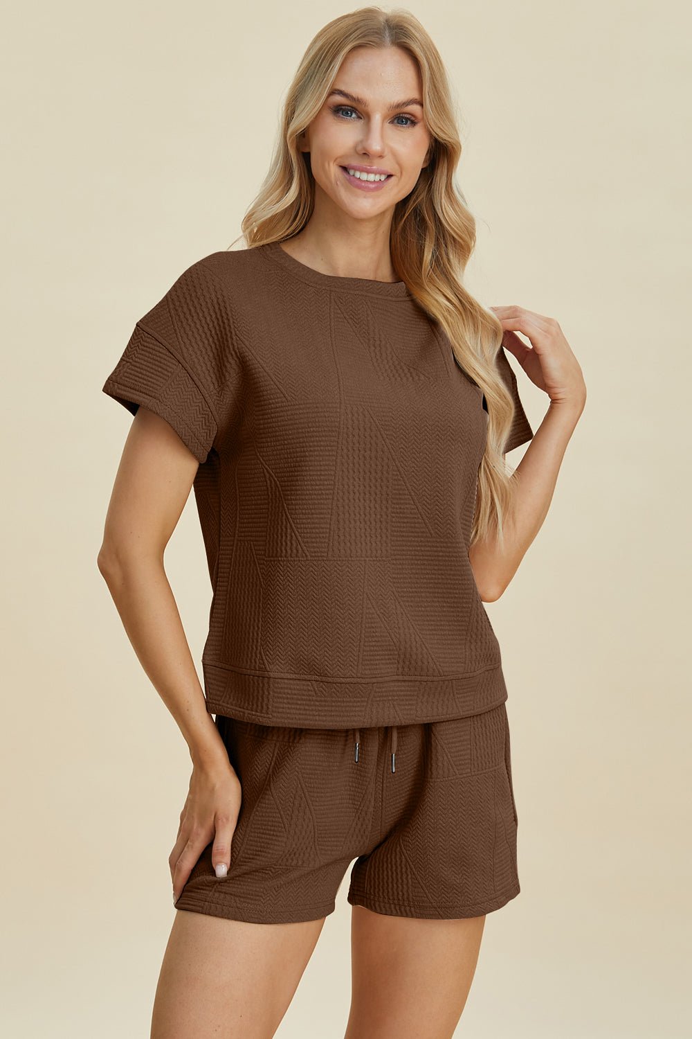 Woman wearing brown full-size texture short sleeve top and shorts set, pocketed, featuring a drawstring, made of polyester and elastane.